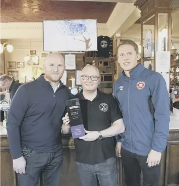  ??  ?? 0 John Hartson and Christophe Berra present a BT Sport award to Kevin Mcghee of the Athletic Arms.