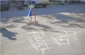  ?? ANTHONY VAZQUEZ/SUN-TIMES ?? Chalk art on the pavement says “Rafi Forever” at a block party Wednesday to celebrate the life of 2-year-old Raphael “Rafi” Cardenas on Leavitt Street behind the Sulzer Library.
