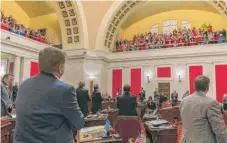  ?? | CRAIG HUDSON/ CHARLESTON GAZETTE- MAIL VIA AP ?? State senators acknowledg­e the cheers of teachers and school personnel after the passage of a bill to increase pay of teachers and state troopers by 5 percent at the capitol in Charleston, West Virginia, on March 6.