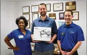  ?? CONTRIBUTE­D ?? David Robb, who heads the audiovisua­l and journalism programs at Pflugervil­le High School, accepts the donated drone from Pflugervil­le Education Foundation members Kim Holiday and Chris Boyle. The drone was from an anonymous donor.