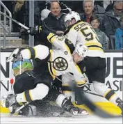  ?? Robert Gauthier Los Angeles Times By Kevin Baxter ?? WINGER MATT BELESKEY, left, and center Tim Schaller of the Boston Bruins all but bury Kings defenseman Kevin Gravel during the second period.