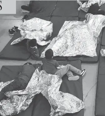  ?? U.S. CUSTOMS AND BORDER PROTECTION’S RIO GRANDE VALLEY SECTOR VIA AP ?? In this photo from U.S. Customs and Border Protection, people taken into custody related to cases of illegal entry into the United States, rest in one of the cages at a facility in McAllen, Tex., Sunday.