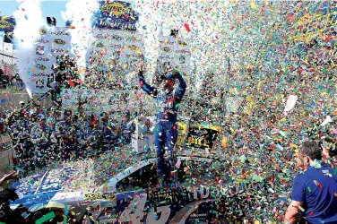  ?? Associated Press ?? Jimmie Johnson celebrates in Victory Lane after he won the NASCAR Sprint Cup series auto race Sunday at Dover Internatio­nal Speedway in Dover, Del.