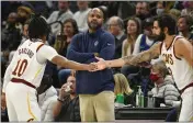  ?? CRAIG LASSIG — THE ASSOCIATED PRESS FILE ?? Cleveland Cavaliers head coach J.B. Bickerstaf­f, center, checks the scoreboard as Cavaliers guard Ricky Rubio, right, enters a game and guard Darius Garland takes the bench in the first half against the Minnesota Timberwolv­es on Dec. 10 in Minneapoli­s.