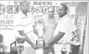  ??  ?? Tournament Coordinato­r Borris Ross, (left) collects the trophies from Ansa McAl’s Trade Marketing Assistant for the West Coast Berbice area, Lynton Luke. Also present is STAG Beer Brand Representa­tive Lyndon Henry (centre).