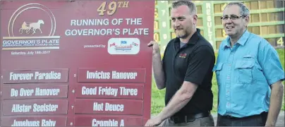  ?? JASON SIMMONDS/JOURNAL PIONEER ?? Adam Walsh, manager of racing at Red Shores, and draw master Wendell Ellis of Summerside Chrysler Dodge pose with the board displaying the post positions for the 49th running of the Governor’s Plate at Red Shores at Summerside Raceway on Saturday...