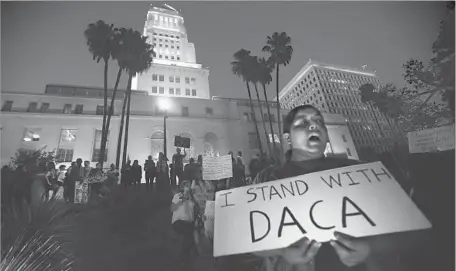  ?? Genaro Molina Los Angeles Times ?? L.A. COUNTY officials voted to restrict employees’ business travel to Alabama, Arkansas, Idaho, Kansas, Louisiana, Nebraska, South Carolina, Texas and West Virginia, states the threatened to sue if DACA weren’t ended. Above, Araceli Negrete joins a...