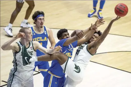  ?? AP photo ?? Michigan State’s Julius Marble II (right) competes for a rebound with UCLA’s Cody Riley next to the Spartans’ Joey Hauser and the Bruins’ Jaime Jaquez Jr. during the first half of the teams’ NCAA Tournament First Four game Thursday.