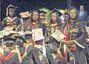  ?? JOHN RAOUX/ASSOCIATED PRESS ?? A group of students stand and turn their backs Wednesday during a commenceme­nt speech by Education Secretary Betsy DeVos at Bethune-Cookman University in Daytona Beach.