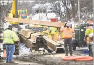  ?? Brian A. Pounds / Hearst Connecticu­t Media ?? Steel shoring is unloaded at the site of the sewer pipe break on Pershing Drive in Ansonia on March 6.