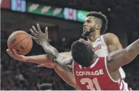  ?? | AP ?? Maryland’s Melo Trimble collides with Indiana’s Thomas Bryant on a drive Tuesday.