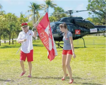  ?? GUSTAVO CABALLERO/GETTY IMAGES ?? British billionair­e Richard Branson arrives Tuesday in Miami by helicopter with banners and models in sailing attire.