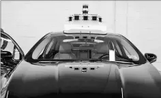  ??  ?? A Ford vehicle that will eventually be made into a self-driving car is outfitted with cameras at the Ford terminal in Washington.