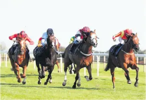  ??  ?? Singing The Blues ridden by Daniel Muscutt (right) wins the Sky Sports Racing Sky 415 Handicap