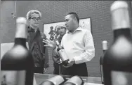  ?? PENG ZHAOZHI / XINHUA ?? Wine merchant Chen Deqi discusses his business with winemakers at his vineyard in the Ningxia Hui autonomous region. Chen started the vineyard in 2007 and built a successful wine brand.