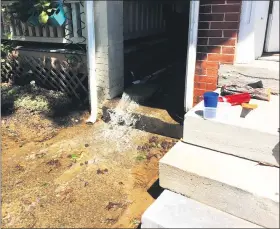  ?? EVAN BRANDT — MEDIANEWS GROUP ?? Water is pumped from a flooded basement on Walnut Street Wednesday.