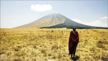  ?? AFP ?? A Massai tribesman stands on the slopes leading up to the Ol Doinyo Lengai volcano in the Ngorongoro Conservati­on Area, northern Tanzania.