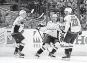  ?? [AP PHOTO] ?? Washington Capitals left wing Andre Burakovsky, center, celebrates his goal against the Tampa Bay Lightning with teammates Dmitry Orlov, left, and Lars Eller during the second period in Game 7 of the Eastern Conference finals Wednesday in Tampa, Fla.