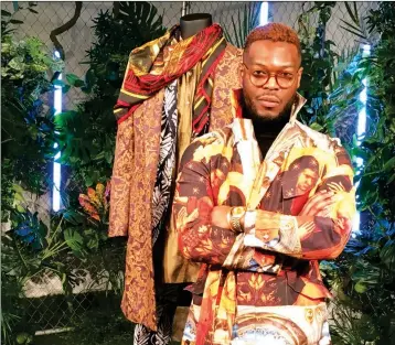  ?? ASSOCIATED PRESS ?? WALE OYEJIDE, FOUNDER OF THE BRAND IKIRE JONES, superhero film “Black Panther,” Monday in New York. stands with his menswear design for a fashion collection inspired by the