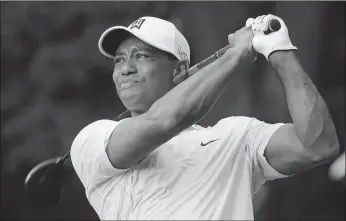  ?? Steve Helber / The Associated Press ?? Tiger Woods drives from the 18th tee during the first round of the Quicken Loans National golf tournament.