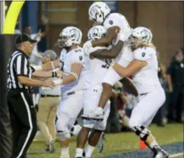  ?? JASON HIRSCHFELD — THE ASSOCIATED PRESS ?? Old Dominion players celebrate a touchdown with Jeremy Cox, second from right, against Virginia Tech Saturday in Norfolk, Va. Old Dominion won, 49-35.