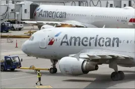  ?? STEVEN SENNE — THE ASSOCIATED PRESS FILE ?? American Airlines jets prepare for departure at Boston Logan Internatio­nal Airport last summer. The airline on Thursday reported a loss of $931million in its fourth quarter.