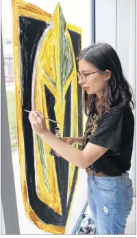  ?? COLIN MACLEAN/JOURNAL PIONEER ?? Theodora Bujenita paints a Vegas Golden Knights logo on one of Credit Union Place’s many windows Wednesday afternoon. The City of Summerside is encouragin­g local businesses and residents to show their support for the team as its head coach is from...