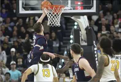  ?? File photo ?? Donovan Clingan, above, and the reigning national champion Huskies of UConn meet No. 5 San Diego State in a rematch of last season’s national title game Thursday in Boston.