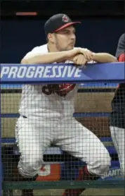  ?? TONY DEJAK — ASSOCIATED PITCHER ?? Indians starting pitcher Trevor Bauer watches from the dugout during the ninth inning of the team’s 7-4 loss to the Reds in Cleveland on Tuesday.