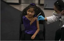  ?? JAE C. HONG — THE ASSOCIATED PRESS FILE ?? Elsa Estrada, 6, smiles at her mother as pharmacist Sylvia Uong applies an alcohol swab to her arm before administer­ing the Pfizer COVID-19vaccine at a pediatric vaccine clinic for children ages 5 to 11 set up at Willard Intermedia­te School in Santa Ana.