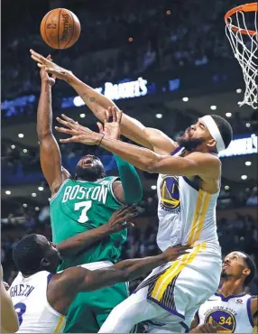  ?? MICHAEL DWYER / AP ?? Boston Celtics’ Jaylen Brown battles Golden State Warriors’ JaVale McGee for a rebound during the first quarter of Thursday’s NBA game in Boston. The Celtics won 92-88.