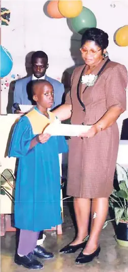  ??  ?? Isolin mckenzie handing over grad cert to student.