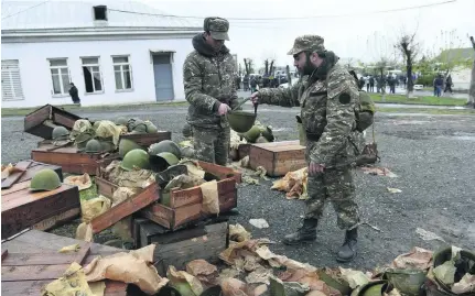  ?? Hayk Baghdasary­an / Reuters ?? Armenian volunteers in Yerevan prepare to be sent to Nagorno Karabakh yesterday. The disputed region is internatio­nally recognised as part of Azerbaijan but is controlled by Russian-backed Armenian separatist­s.