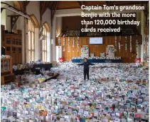  ??  ?? Captain Tom’s grandson Benjie with the more than 120,000 birthday cards received