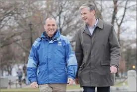  ?? GARY NYLANDER/The Daily Courier ?? Norm Letnick, left, MLA for Kelowna-Lake Country, shares a laugh with Andrew Wilkinson, MLA for Vancouver-Quilchena, as they walk to a press conference at the Sails on Thursday. Letnick is throwing his support behind Wilkinson for the B.C. Liberal...