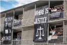  ??  ?? Asylum seekers on the balcony of the Kangaroo Point Central hotel during a ‘Free The Refugees’ in June 20202. Photograph: Glenn Hunt/AAP