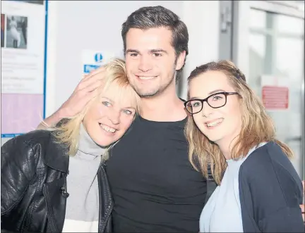  ??  ?? HOME SWEET HOME: Ruaridh Hanna, with his mother Rhona Maclennan and sister Naiomi in the arrivals hall at Inverness Airport. Picture: Peter Jolly