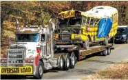  ?? STAFF FILE PHOTO BY DOUG STRICKLAND ?? A wrecker removes the bus from the scene at Talley Road in Chattanoog­a on Nov. 22, the day after the fatal Woodmore Elementary School bus crash.