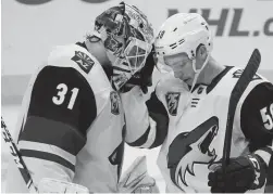  ?? ROBERT HANASHIRO/USA TODAY SPORTS ?? Coyotes goaltender Adin Hill (31) and left wing Michael Bunting celebrate after a win over the Kings on Monday night.