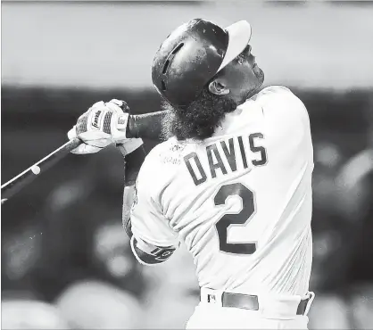  ?? BEN MARGOT THE ASSOCIATED PRESS ?? Oakland Athletics’ Khris Davis wears a jersey signed by Anthony Slocumb, a child from the Make-A-Wish Foundation, seen on Davis’ left shoulder. Davis hit his 37th home run of the season wearing the signed jersey.