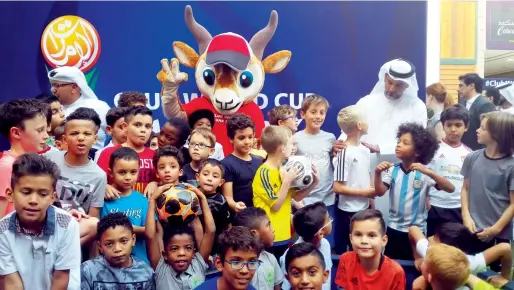  ?? Photo by Ashwani Kumar ?? Fifa Club World Cup UAE 2017 Higher Local Organising Committee officials and fans pose with mascot ‘Dhabi’. —