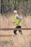  ?? Lori Van Buren / times union ?? A runner is seen on a trail at the Albany Pine Bush Preserve during a light rain on April 21 in Albany.