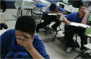  ?? (Photo by Brennan Linsley, AP) ?? In this Jan. 24, 2008 file photo, students sit at their desks inside a classroom, at Republica del Peru middle school, in San Juan, Puerto Rico. The U.S. territory is closing 184 public schools, officials announced Friday, May 5, 2017, in a move...