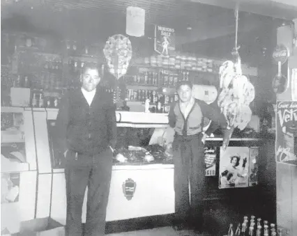  ?? COURTESY OF RUDY BESERRA ?? Max Beserra, left, and Frank Beserra Sr., Rudy Beserra’s grandfathe­r and father, stand in their Barelas store.