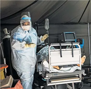  ?? JEROME DELAY/AP ?? COVID-19 patients are treated Friday at a hospital in Pretoria, South Africa. The country’s cases have doubled in two weeks.