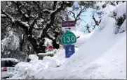  ?? ?? Snow piles up atop Highway 130at Lick Observator­y on Mount Hamilton east of San Jose on Tuesday.