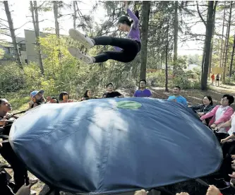  ?? CLIFFORD SKARSTEDT/ EXAMINER ?? A student is tossed in midair on an Inuit throwing blanket as 225 students from more than 75 nations participat­ed in Trent University’s Internatio­nal Orientatio­n organized by The Land Canadian Adventures on Wednesday. See more photograph­s from the...