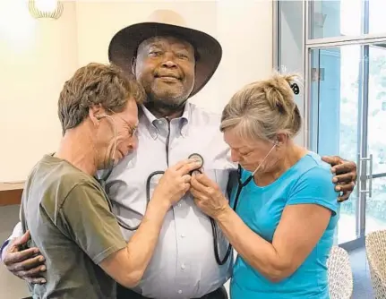  ?? JOSHUA SHETTERLY PHOTO ?? Michael and Barbara Shetterly of Essex listen to their son Matthew's heart beat inside Erv Basdon, who received their son's heart after Matthew died of a drug overdose in 2014.