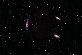  ?? David Cater/Special to the Herald-Leader ?? Pictured are the three spiral galaxies in Leo called “The Triplet.”