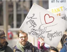  ?? JAMES BLOCKER/TNS ?? Peter Pedemonti, co-director of the New Sanctuary Movement of Philadelph­ia, holds a sign during an immigratio­n protest in 2018.